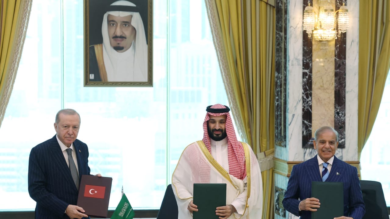 Turkish President Tayyip Erdogan, Saudi Crown Prince Mohammed bin Salman and Pakistan's Prime Minister Shehbaz Sharif pose after signing a joint defense agreement in Mecca, Saudi Arabia, August 7, 2026.