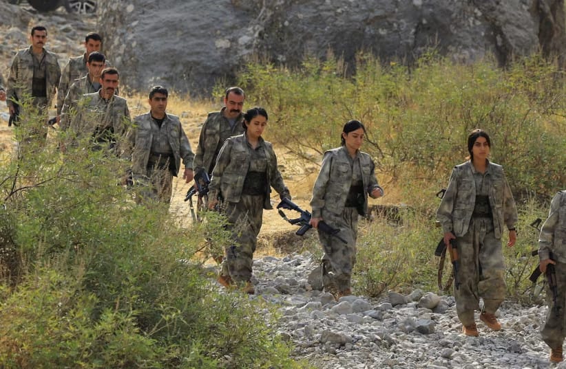 Fighters with the Kurdistan Workers' Party (PKK) walk for a disarmament ceremony marking a significant step toward ending the decades-long conflict between Turkey and the outlawed group, in the Qandil mountains, Iraq October 26, 2025.