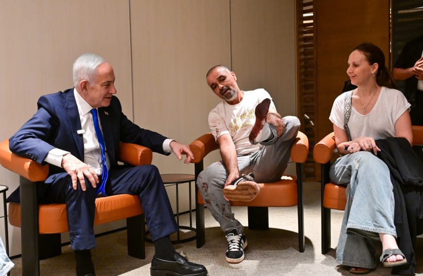 Prime Minister Benjamin Netanyahu speaks with one of the passengers from the hijhacked flydubai flight at Ben-Gurion Airport on September 30, 2026.