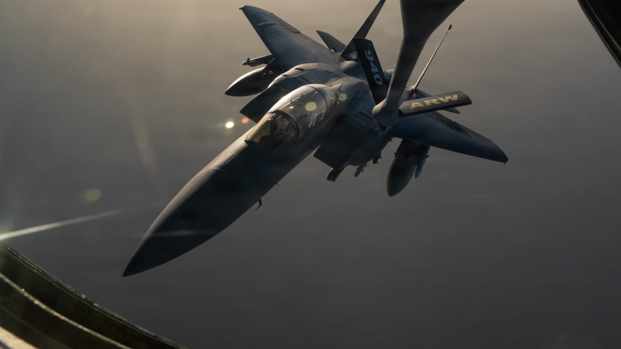 A US Air Force F-15E Strike Eagle is refueled by a KC-135 Stratotanker while patrolling the skies over the Middle East.