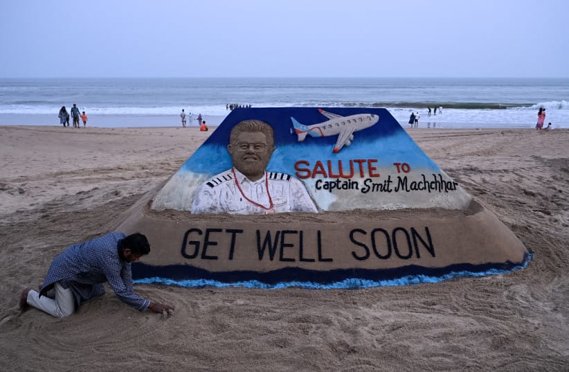A sculpture made by India's sand artist Sudarsan Pattnaik depicts India's pilot Smit Machchhar, the captain of flydubai flight FZ 1073, at a beach in Odisha's Puri city on October 1, 2026.