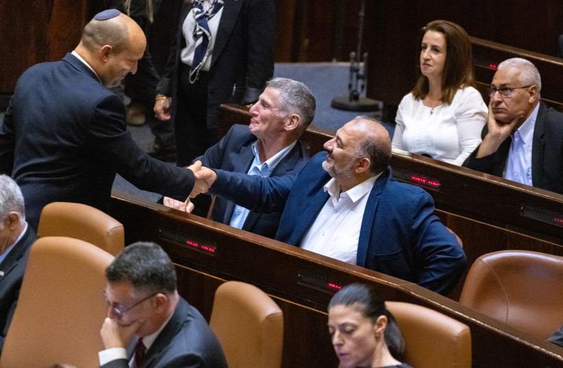 Then-prime minister Naftali Bennet with with head of the Ra'am party Mansour Abbas in the assembly hall of the Israeli parliament on June 21, 2021.