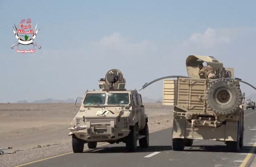 Military vehicles travel along a road during what Saudi-backed Yemeni government forces say was an advance against the Iran-backed Houthis, near Dhubab, Taiz Governorate, Yemen, in this still image taken from video released October 5, 2026.
