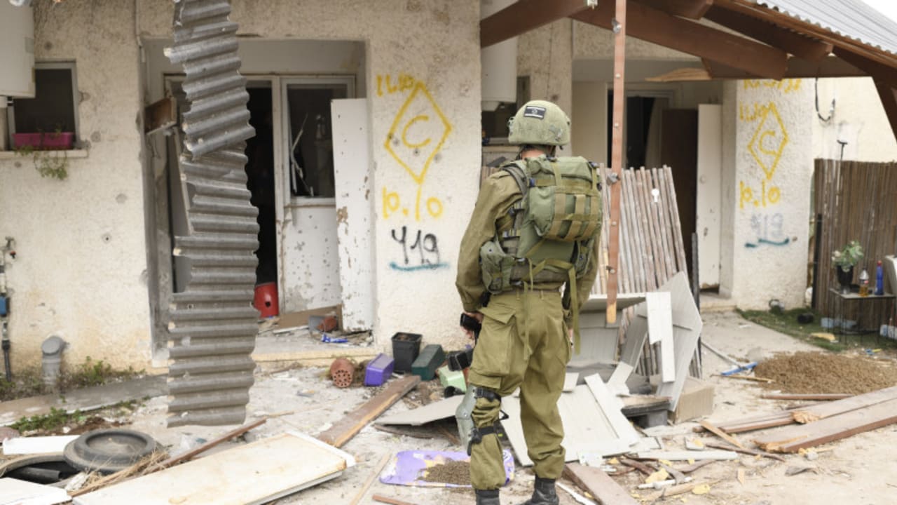 A soldier views the destruction on October 7.