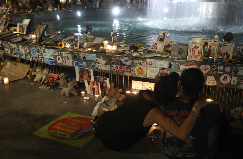People gather to mark the first anniversary of the October 7, 2023 ; illustrative (credit: GIL COHEN-MAGEN / AFP)