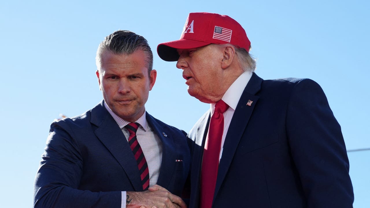 US Defense Secretary Pete Hegseth shakes hands with US President Donald Trump onstage during an event at Sparrows Point Shipyard, in Baltimore County, Maryland, US, October 6, 2026.