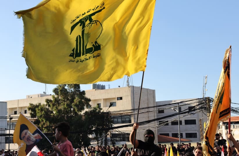 Supporters of Lebanese Shia movement Hezbollah wave flags of the group during a ceremony held to mark the second anniversary of the killing of leader Hassan Nasrallah in a strike by Israel, in Beirut's southern suburbs on September 27, 2026. 