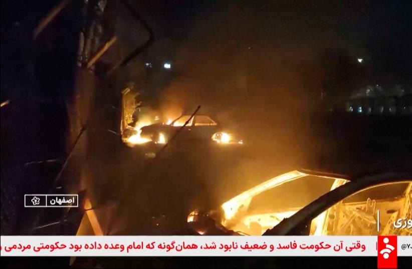 ILLUSTRATIVE: Flames engulf cars following unrest sparked by dire economic conditions, in a place given as Isfahan, Iran, January 9, 2026, in this screengrab from Iran's state media broadcast footage. (credit: IRIB/WANA