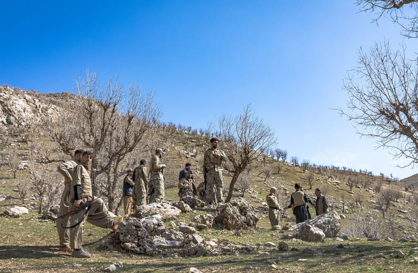 Members of Komala of the Toilers of Kurdistan gather near a fortified position at a mountain base in Khalifan near Erbil, Iraq's Kurdistan region, on March 12, 2026.