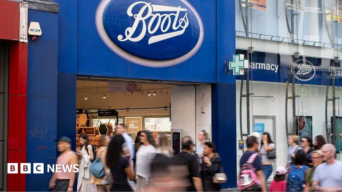 Shoppers walk by a Boots store in central London
