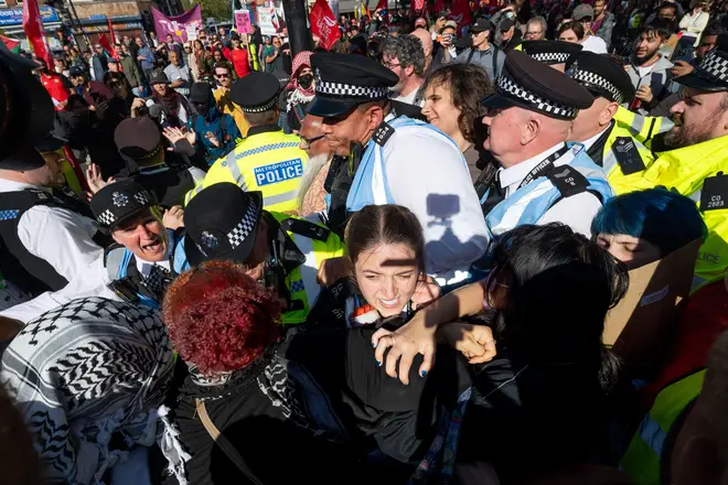 London, UK. 4th Oct, 2026. Protesters scuffles with police during a march. Thousands of people gathered in East London for a march marking the 90th anniversary of th