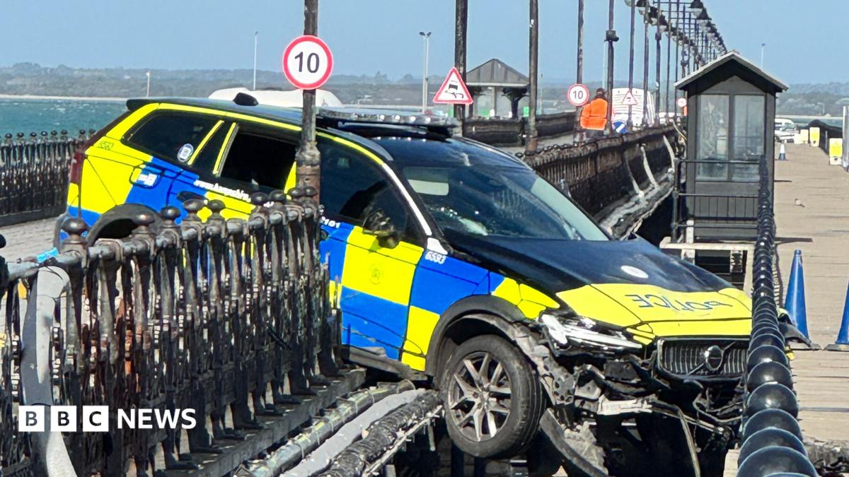 Police car through railings on Ryde Pier.
