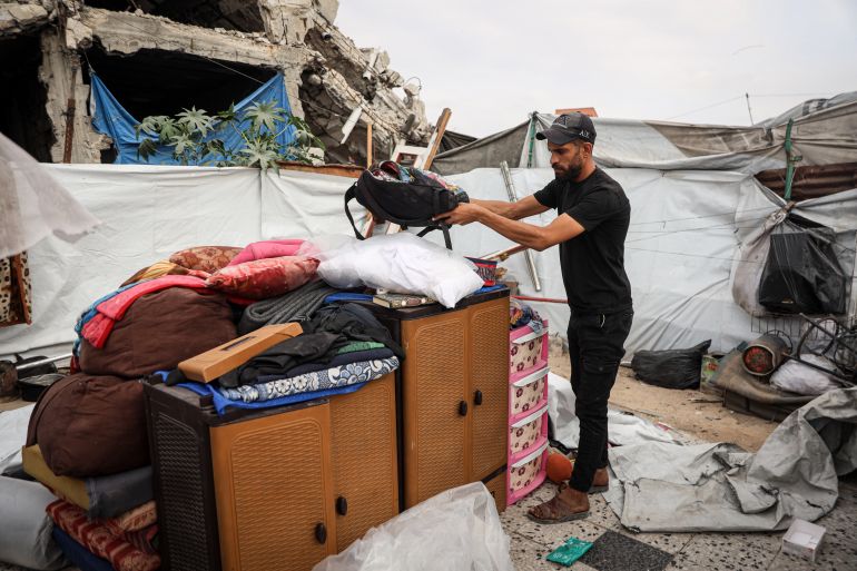 A Palestinian family’s belongings lie beside their tent in Shujaiya, where residents fear further displacement. [Abdelhakim Abu Riash/Al Jazeera]