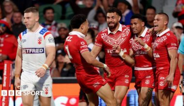 George Williams looks dejected as Tonga celebrate