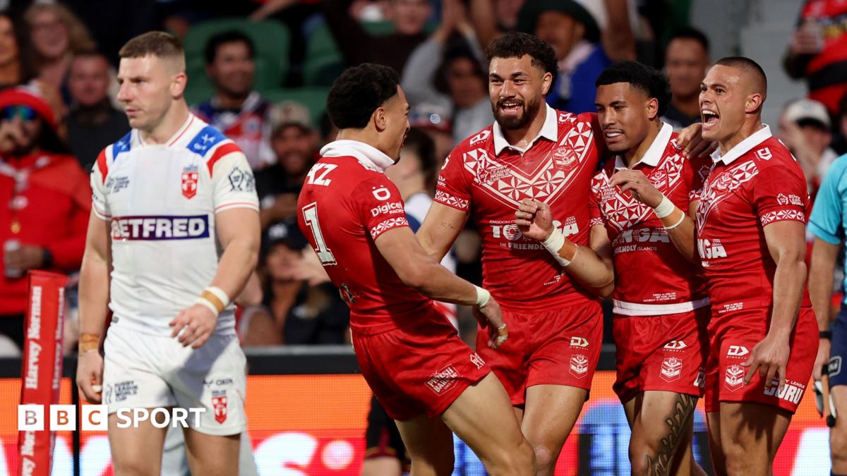 George Williams looks dejected as Tonga celebrate