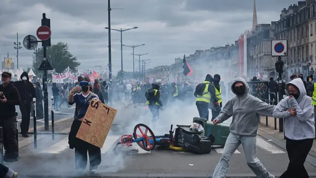 Smoke billows from the ground up as protesters gather on the streets of Bordeaux