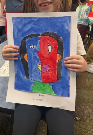 Nikki Anderson's daughter, 6, holding a portrait she made.
