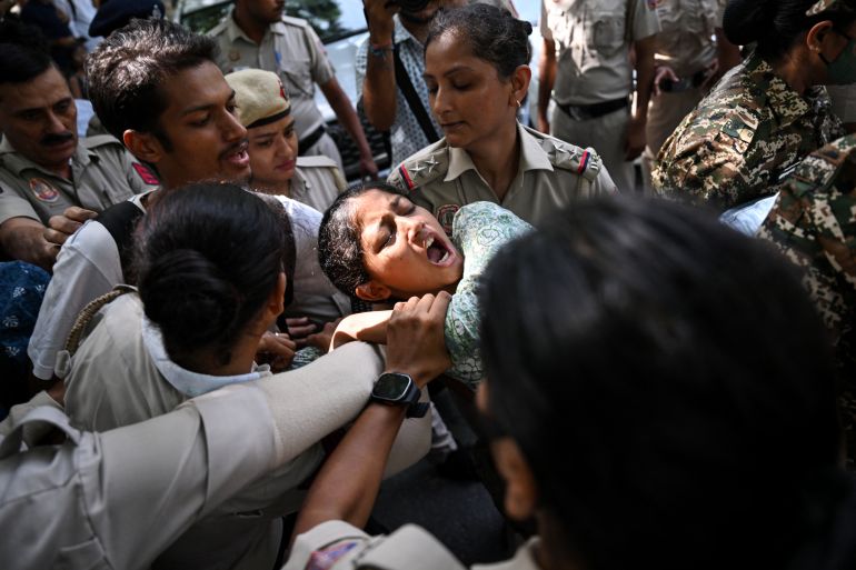 Police and security personnel detain a protester during a demonstration against India's Chief Election Commissioner Gyanesh Kumar in New Delhi on October 3, 2026, to demand his resignation [Arun SANKAR / AFP]