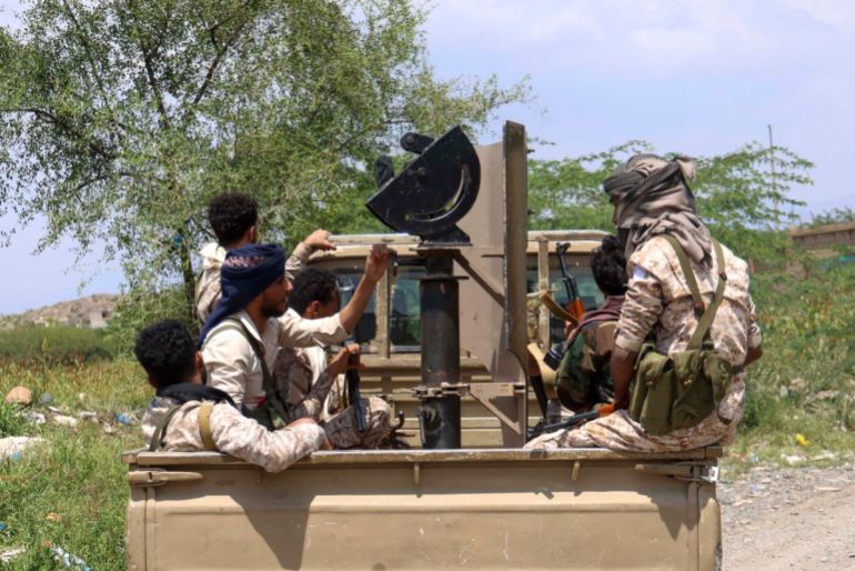 Saudi-backed Yemeni government forces ride in the back of a military truck at the Jabal Han front west of the city of Taiz