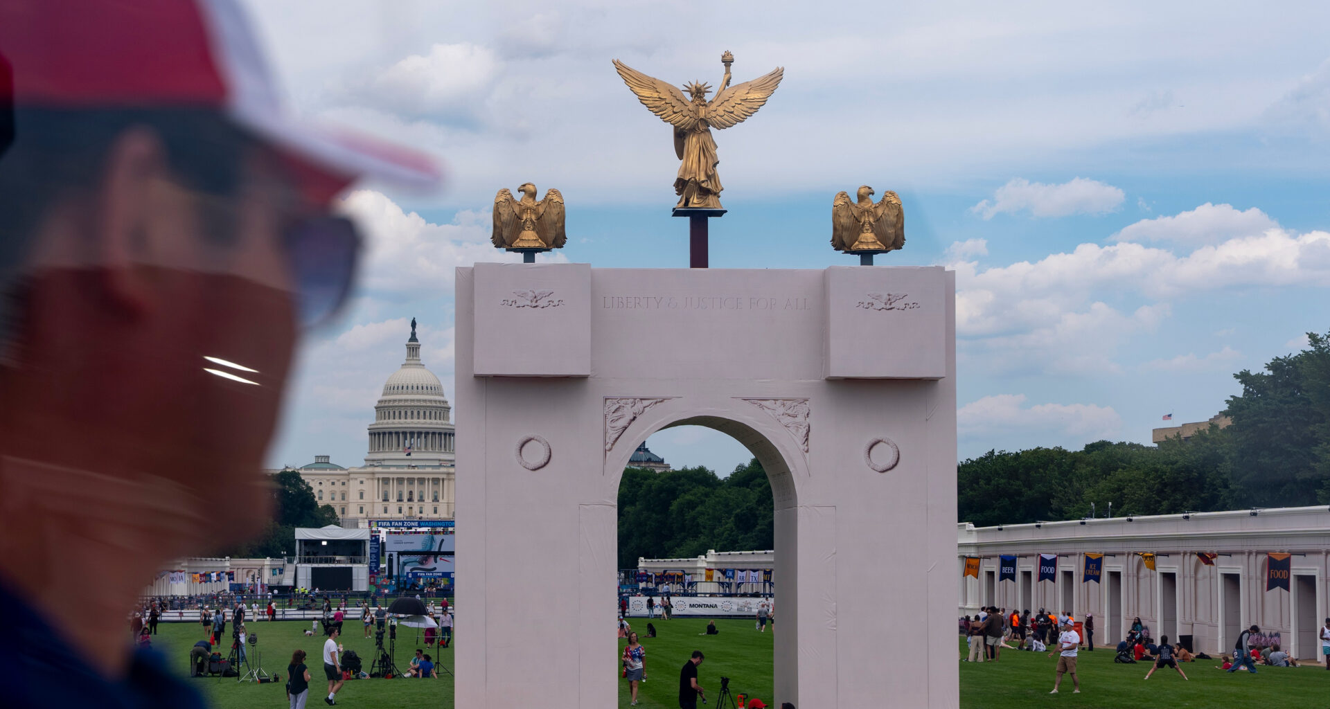 The U.S. Capitol and a mock-up of President Donald Trump's proposed triumphal arch are seen from the ferris wheel at the Great American State Fair on the National Mall, Thursday, June 25, 2026, in Washington. (AP Photo/Jen Golbeck)