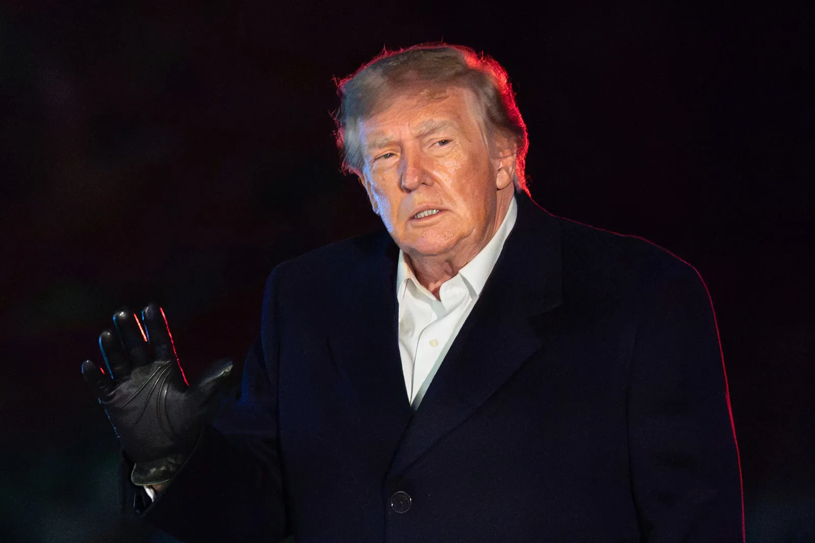 President Donald Trump raises a gloved hand on the South Lawn of the White House in Washington, D.C., on October 8.