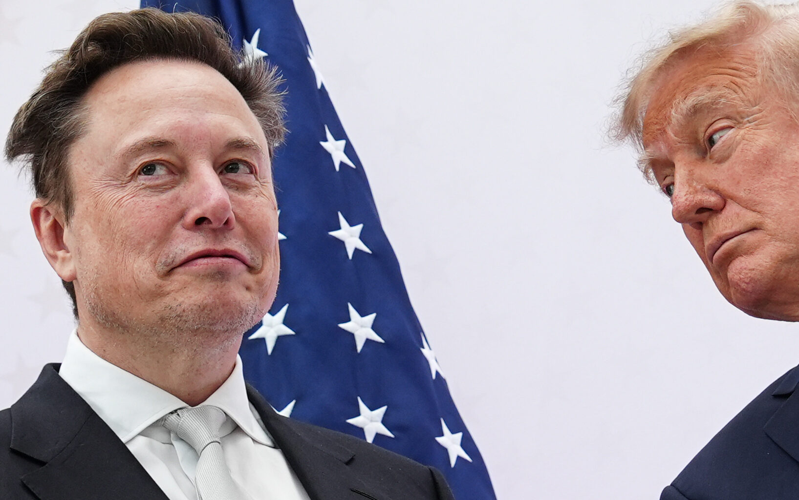 Musk with Trump, American flag in the background
