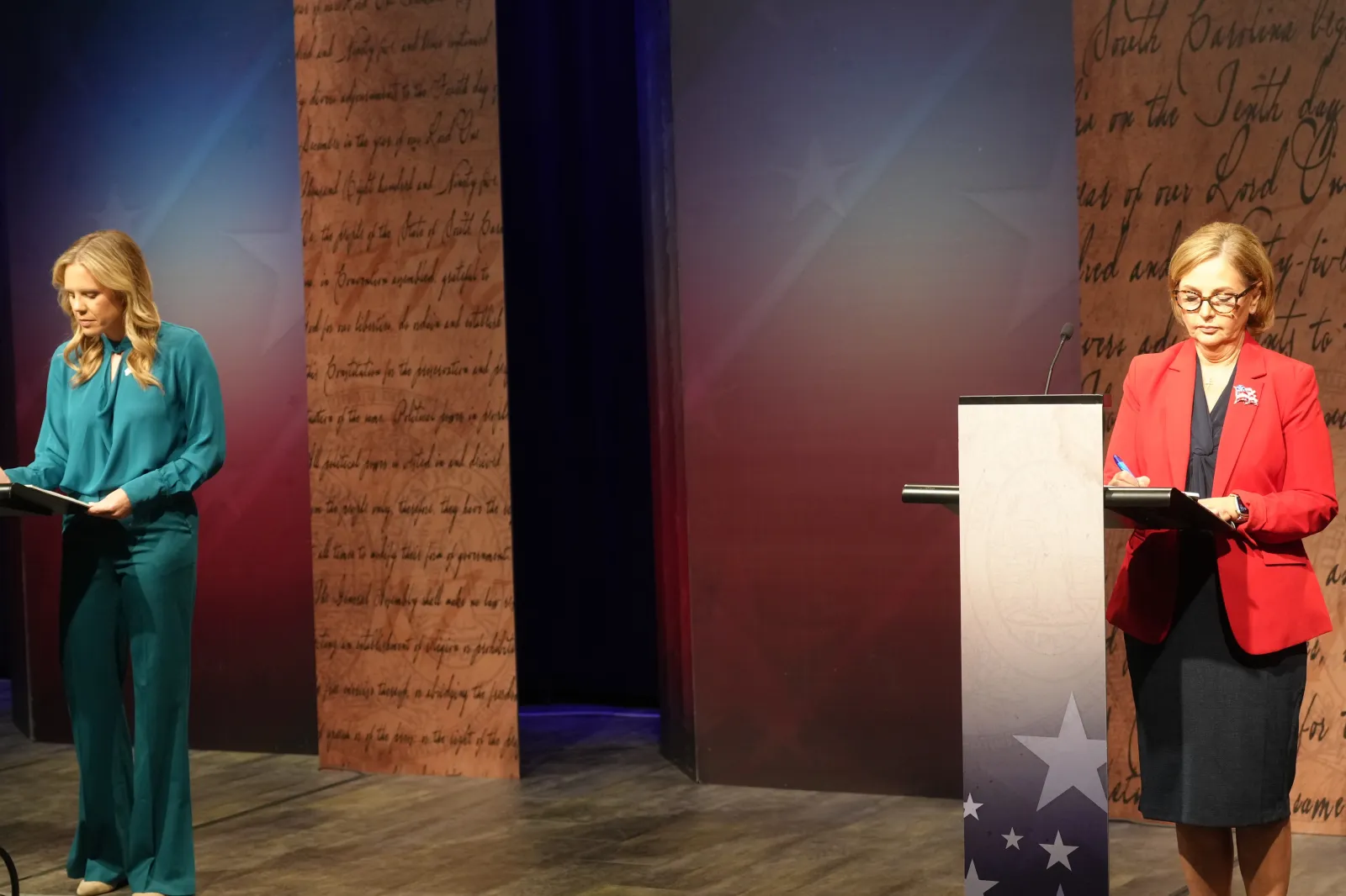 Dr. Annie Andrews, Democratic nominee for Senate in South Carolina, left, and Senator Darline Graham write notes ahead of a debate on October 11 in Columbia. (AP Photo/Meg Kinnard)