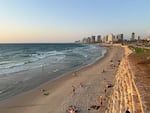 Israelis prepare for an early evening swim in the beach town of Jaffa. To the north are the high-rises of Tel Aviv, home to hotels, apartment buildings and tech companies.
