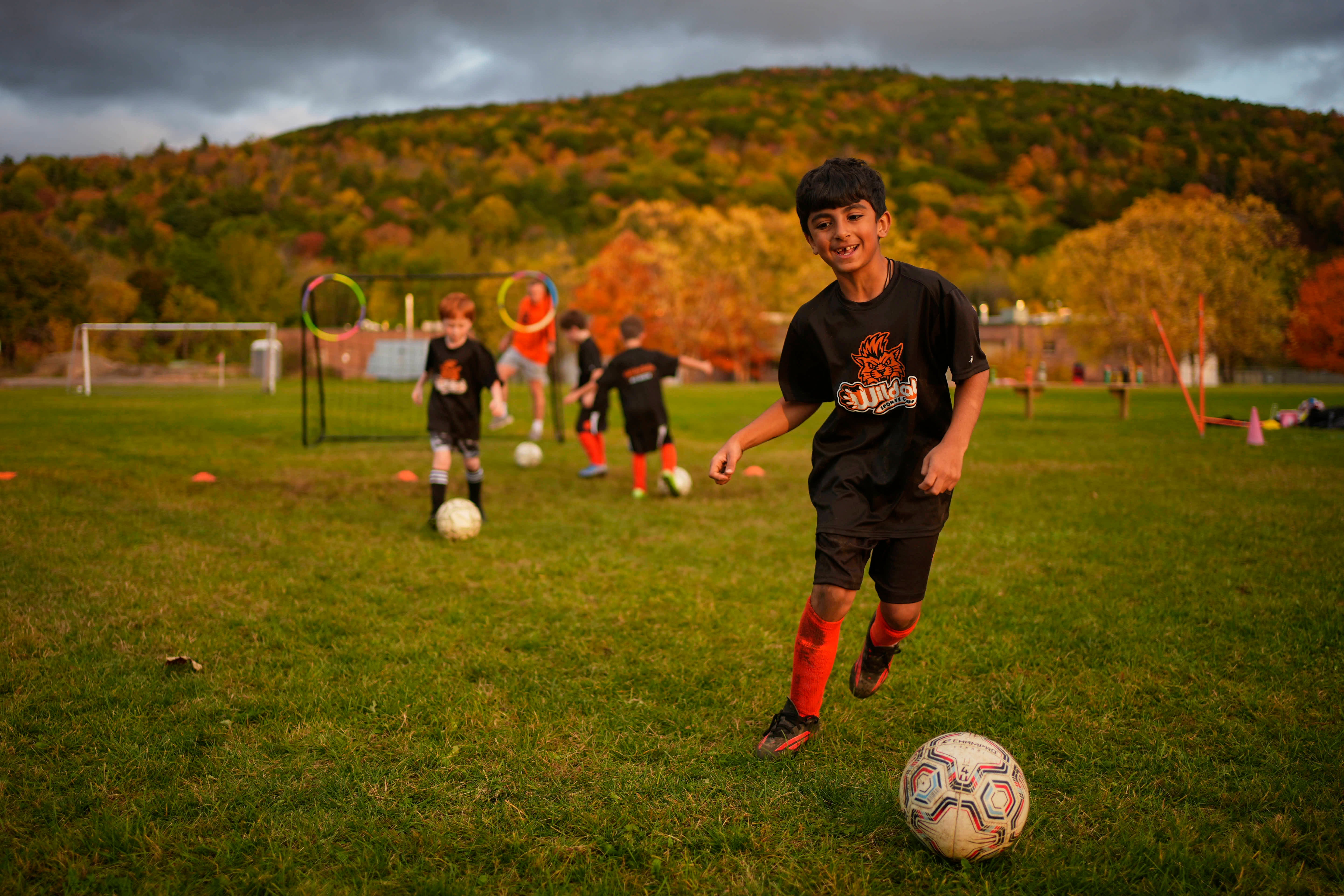 Autumn-colored foliage in Berkshire County serves as backdrop where Krish Panwala practices soccer with his Wildcat teammates, Oct. 12, 2026, in Lee, Mass