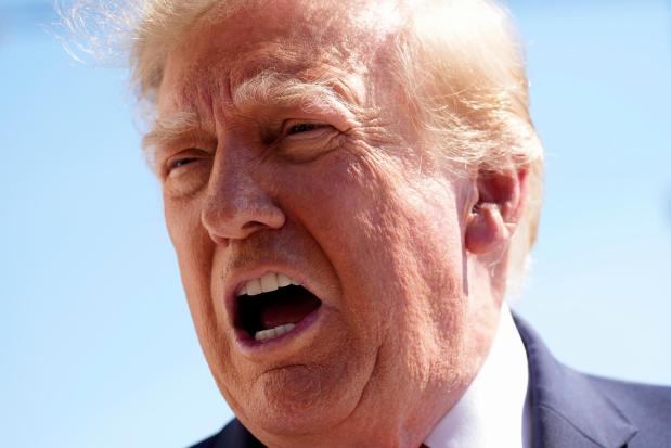 President Donald Trump speaks with reporters before boarding Marine One on the South Lawn of the White House, Thursday Oct. 1, 2026, in Washington. (AP Photo/Jacquelyn Martin)