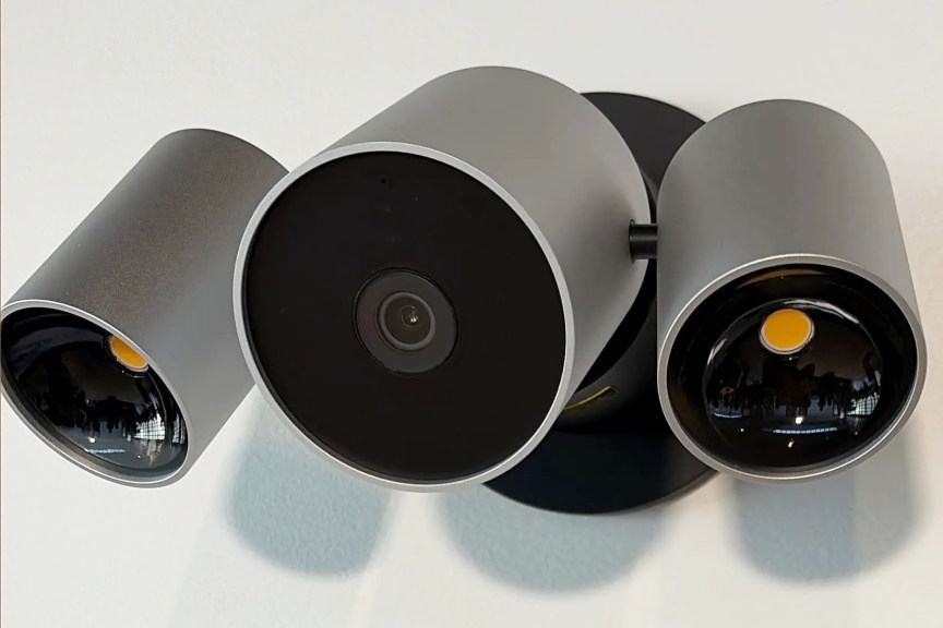 Apple LG floodlight camera displayed on a wall.