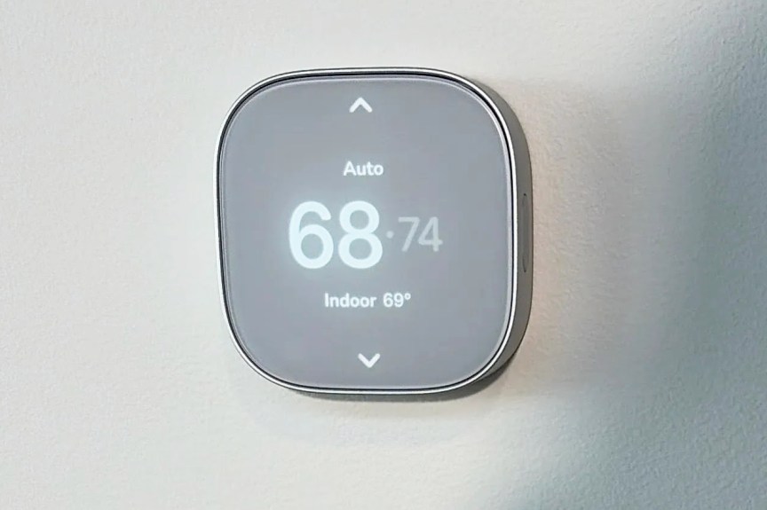 Apple Schneider thermostat displayed on a wall.