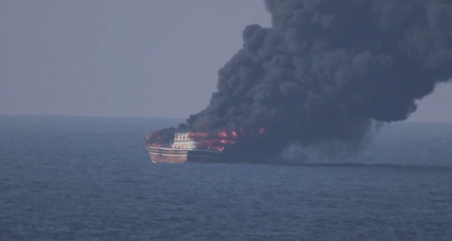 Dhow engulfed in flames in the Gulf of Oman, sending a massive plume of thick black smoke into the sky following a U.S. military strike on October 6, 2026.