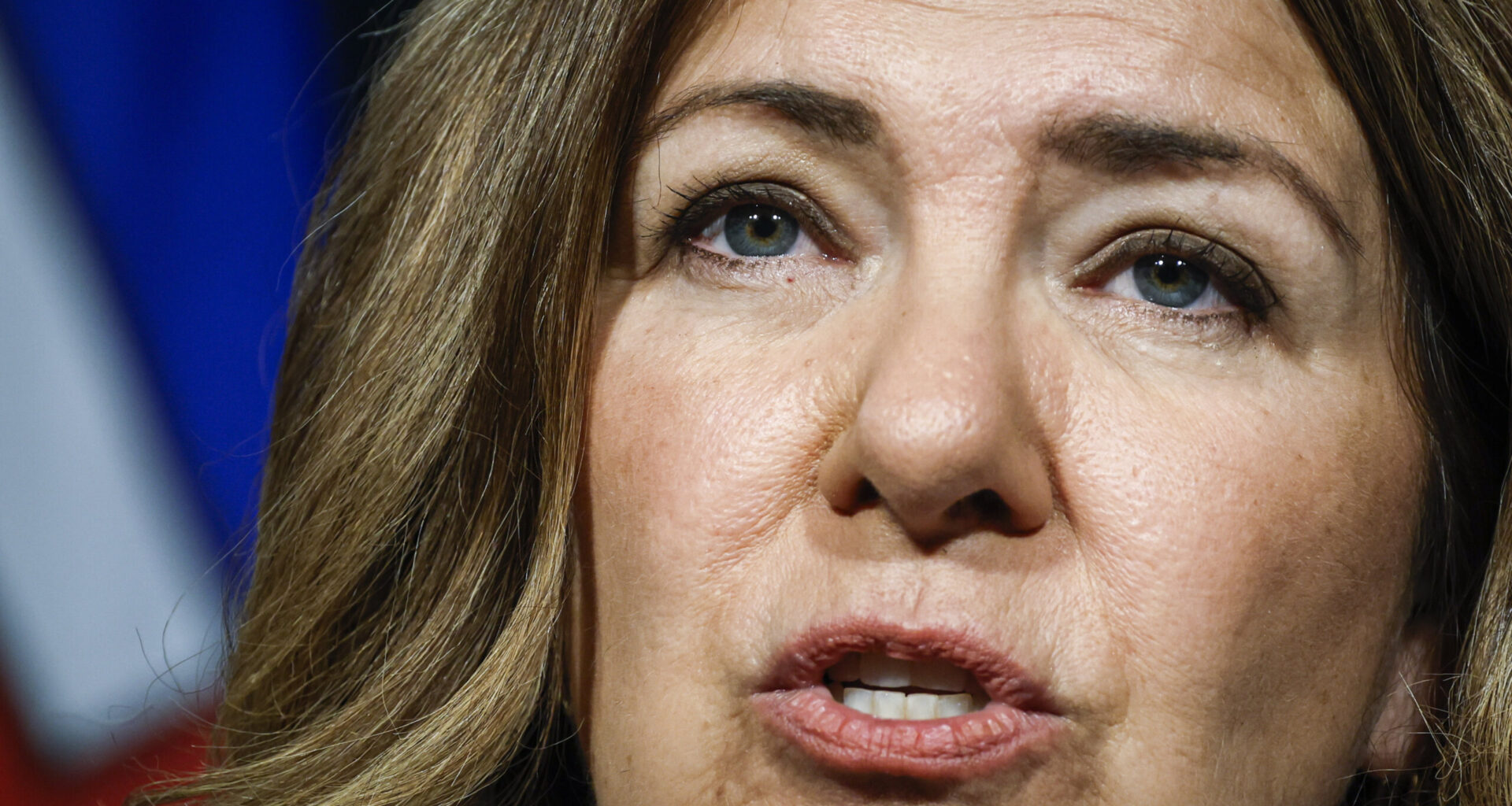 A close-up photo of Danielle Smith speaking