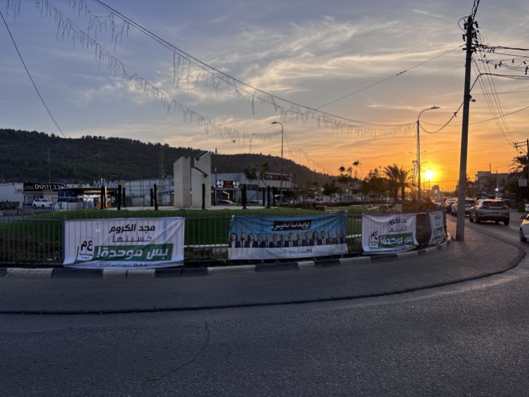 Election campaign posters in Majd al-Krum [Al Jazeera]