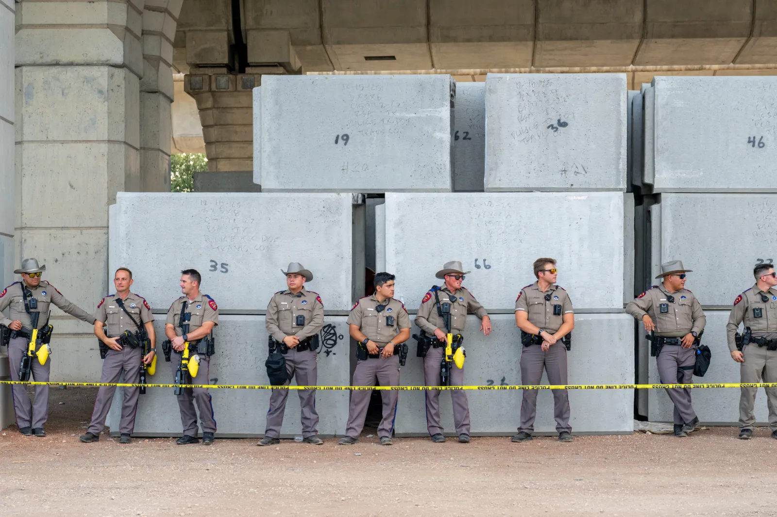 Law enforcement stand and watch as people protest against Immigration and Customs Enforcement officers on September 20, 2026 in Austin, Texas.