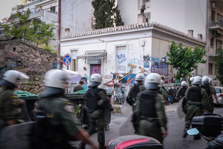 Riot police walk through Exarchia
