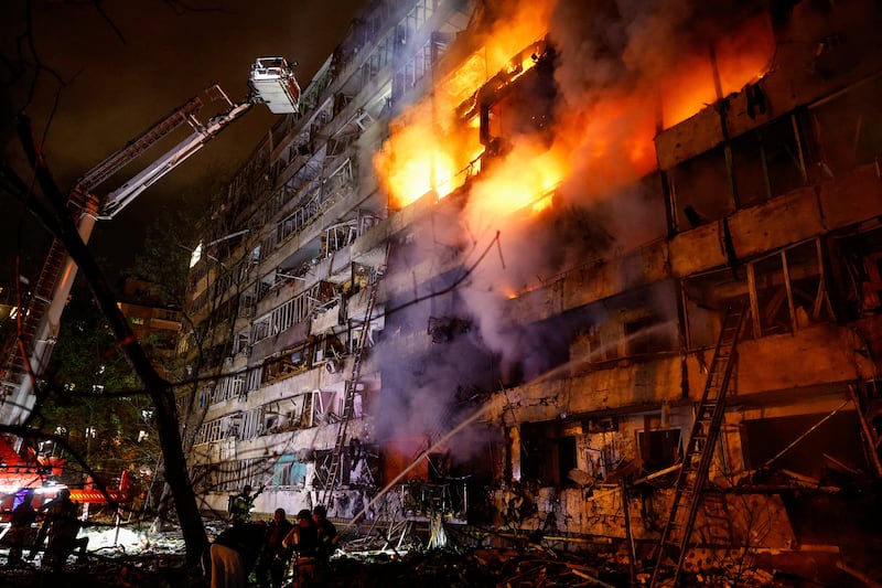 Firefighters work at the site of an apartment building damaged by a Russian missile strike, amid Russia's attack on Ukraine, in Kyiv, Ukraine October 14, 2026. REUTERS/Valentyn Ogirenko