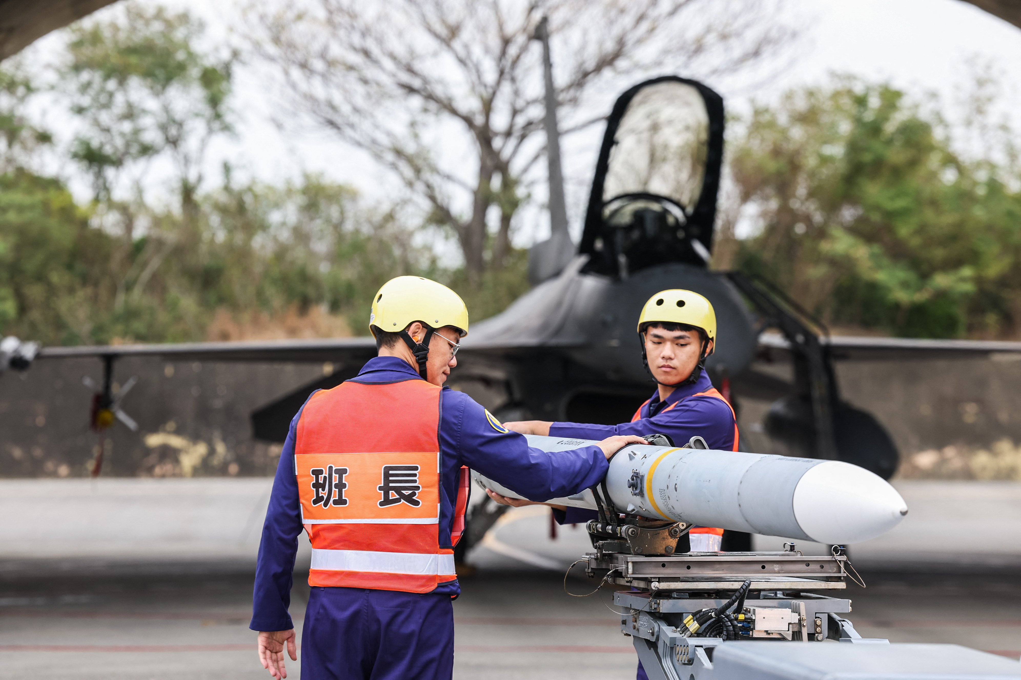 TOPSHOT - An AIM-120 Advanced Medium-Range Air-to-Air missile is being prepared to be loaded onto a F-16V fighter jet during Spring military exercise at Chiayi Air Base, in Chiayi on January 28, 2026. (Photo by I-Hwa Cheng / AFP via Getty Images)