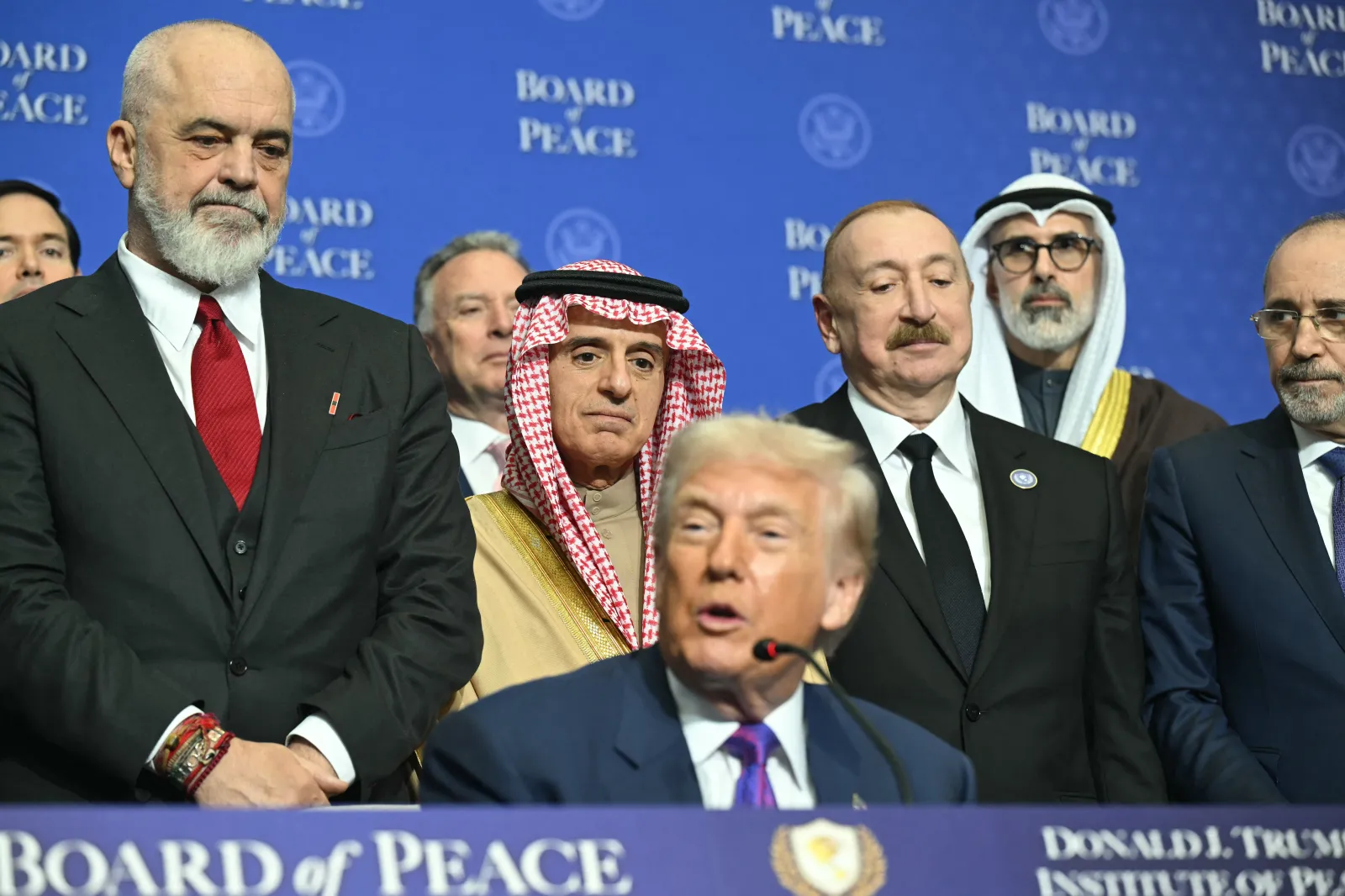 From left, Albanian Prime Minister Edi Rama, Saudi Arabian Minister of State for Foreign Affairs Adel al-Jubeir and Azerbaijan's President Ilham Aliyev look on as U.S. President Donald Trump speaks during a signing ceremony at the inaugural meeting of the "Board of Peace" at the U.S. Institute of Peace in Washington, D.C., on February 19.