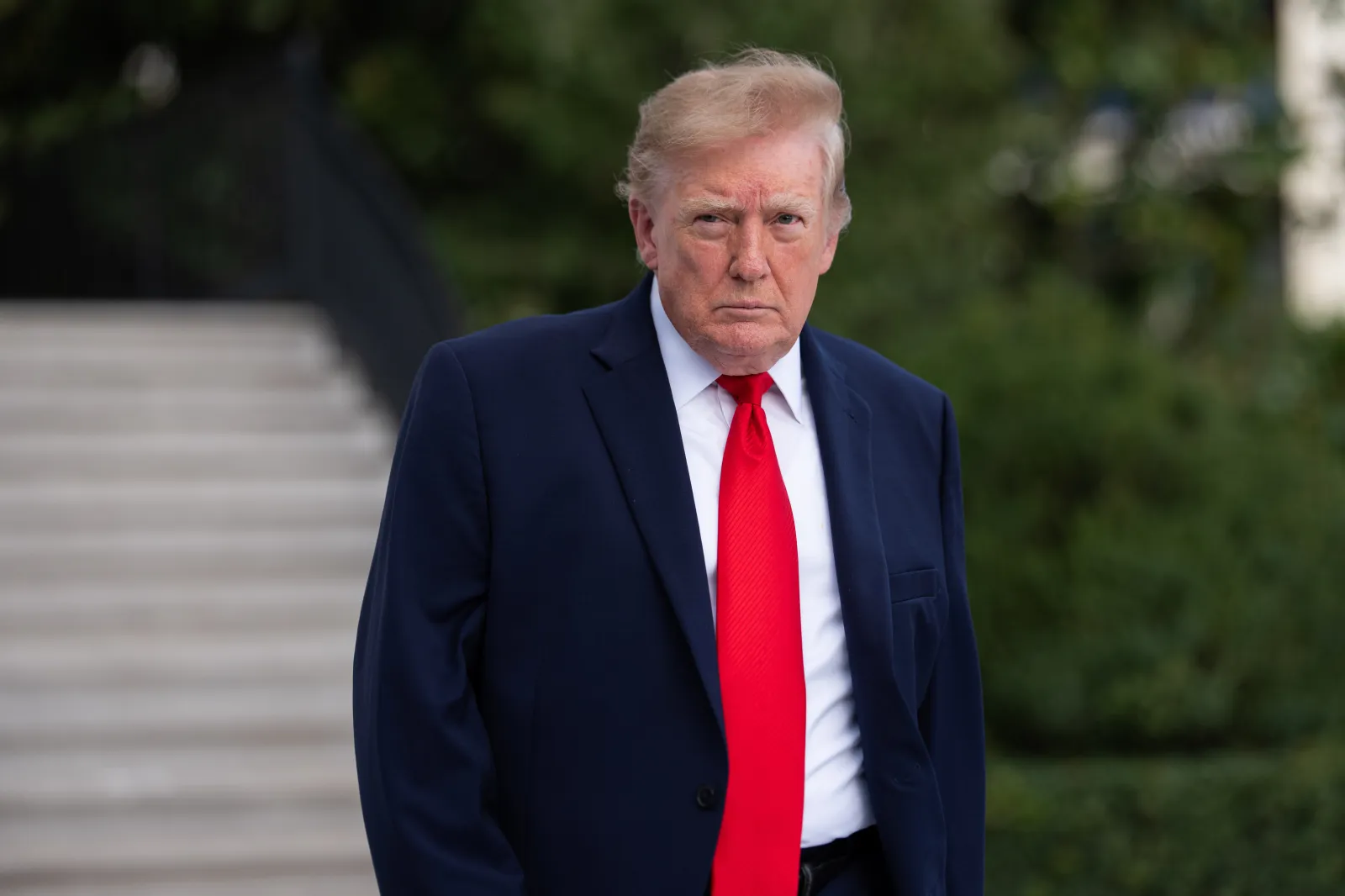 President Donald Trump walks on the South Lawn as he departs the White House on October 12, 2026, in Washington. (Photo by Aaron Schwartz/Getty Images)