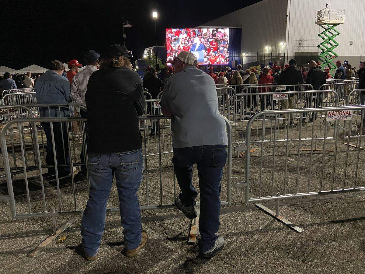People watch the later part of President Trump’s speech in Kansas outside of Heartland Credit Union Arena.