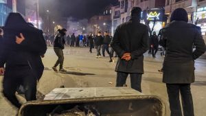Protesters stand on a nighttime city street in Iran during the January 2026 uprising