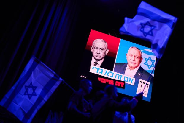 A screen projects an image of Israeli Prime Minister Benjamin Netanyahu and rival Gadi Eisenkot.