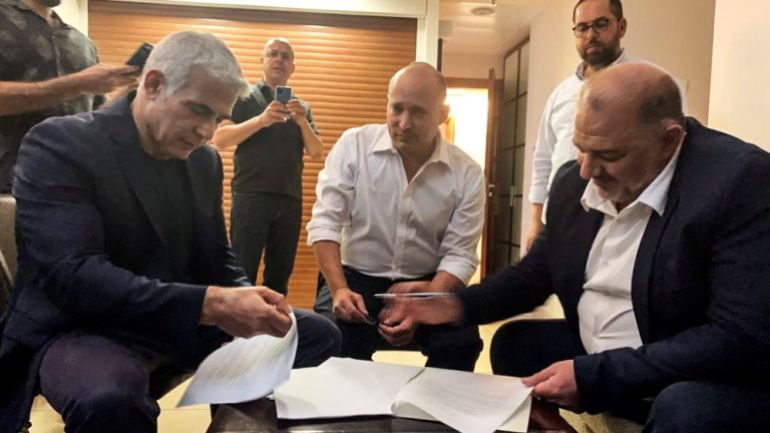 Mansour Abbas, former Yamina party leader Naftali Bennett and Yesh Atid party leader Yair Lapid, sit together in Ramat Gan, near Tel Aviv, Israel June 2 2021