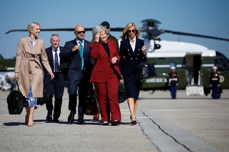White House Chief of Staff Susie Wiles, US President Donald Trump's Executive Assistant Natalie Harp and new White House Press Secretary Katie Zacharia walk to board Air Force One for a trip to Alaska at Joint Base Andrews, Maryland, US, October 13, 2026. REUTERS/Evan Vucci