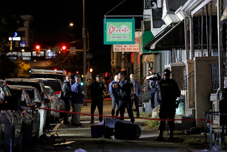Philadelphia police on the scene at 140 North 52nd St., where two officers were ambushed by a man with a shotgun overnight Saturday.