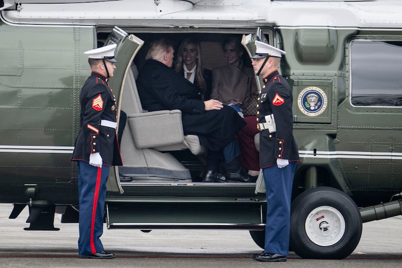 US President Donald Trump speaks with White House Press Secretary Katie Zacharia and aide Natalie Harp after boarding Marine One at Elmendorf Air Force Base in Anchorage, Alaska, on October 13, 2026. President Trump is traveling to Wasilla, Alaska to hold a campaign rally ahead of the midterm elections. (Photo by Kent NISHIMURA / AFP via Getty Images)