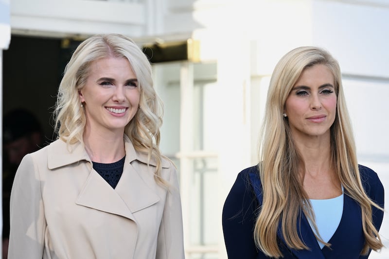 Katie Zacharia, White House press secretary, and US President Donald Trump's Executive Assistant Natalie Harp stand outside the White House, in Washington, DC, US, October 12, 2026. REUTERS/Annabelle Gordon
