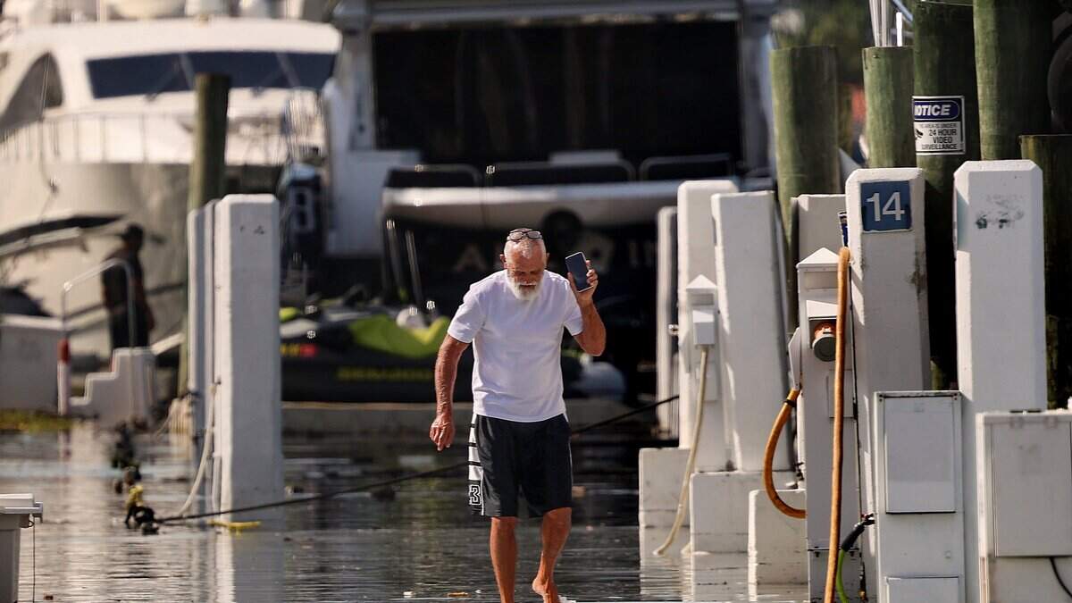 A yacht operator surveys floodwaters at the Fontainebleau Marina on Miami Beach, Fla., during a king tide on Monday, Sept. 28, 2026. The seasonal high tide caused flooding in low-lying areas across Miami-Dade County.